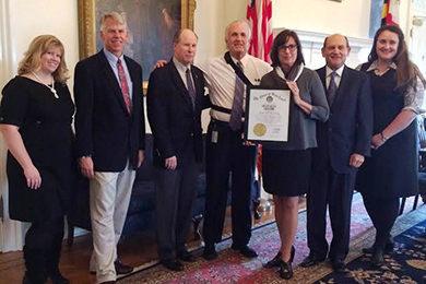 Chief of Staff Griffin (in white) presents O’Day with her award on behalf of Governor O’Malley. 